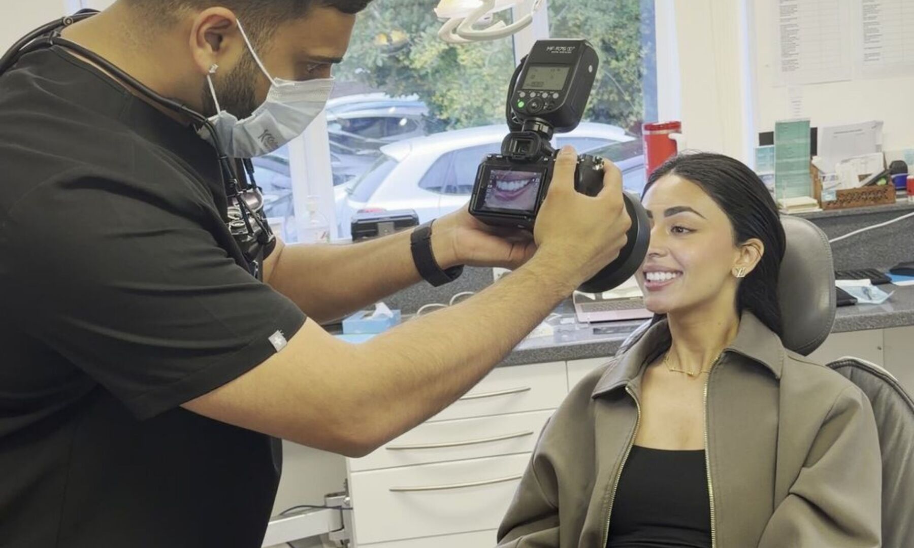 Cameron taking a patient&rsquo;s clinical photographs at the practice