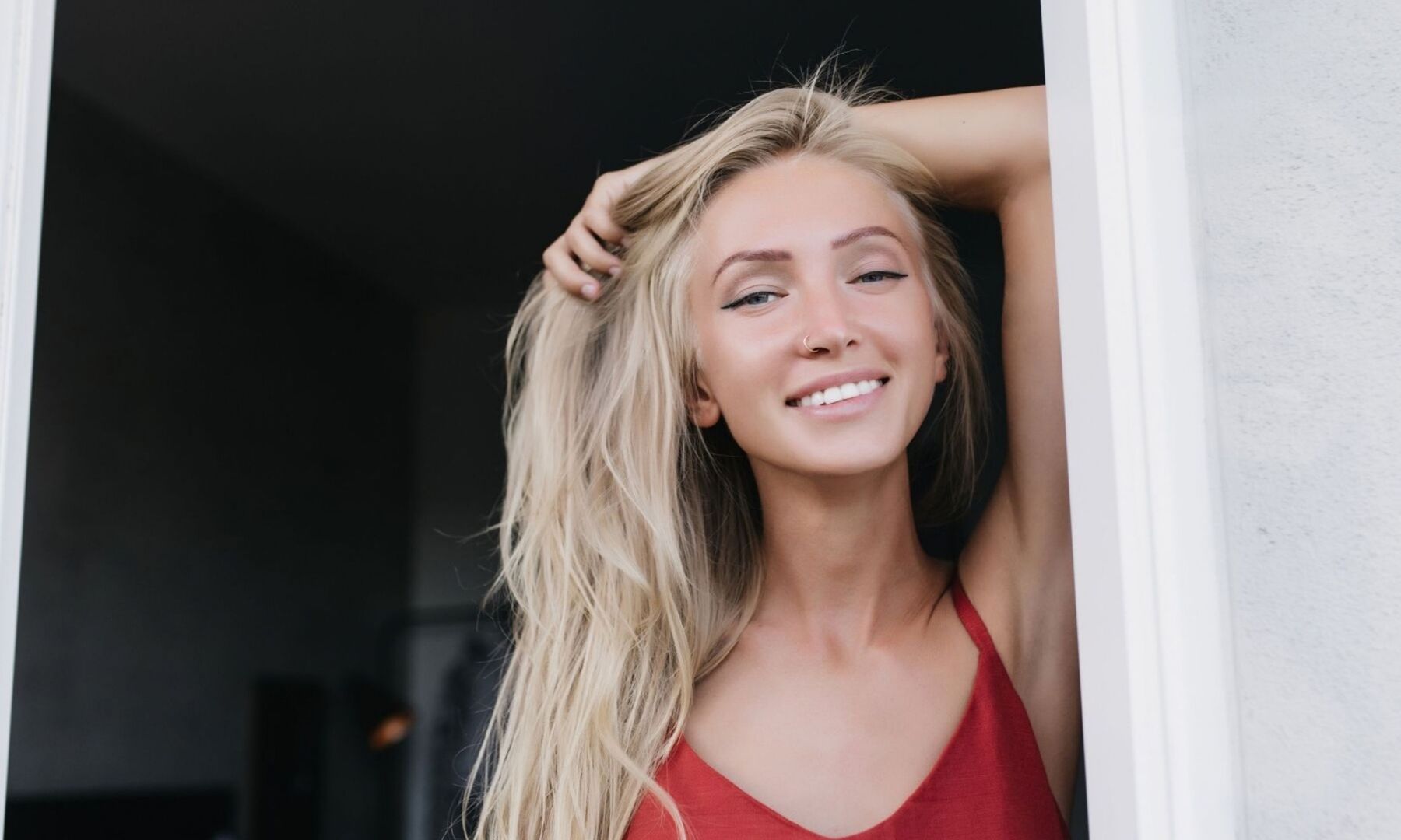 A woman smiling in a doorway
